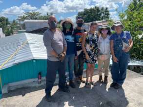 Carmen with the team and her new roof