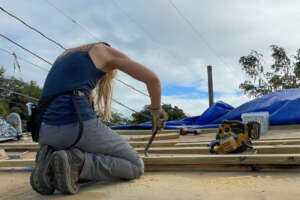 Team member securing lumber for the new frame