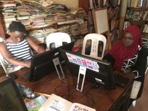 Young girls learning how to us a computer