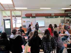 Student leading a presentation at a school