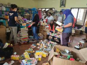 Teachers/volunteers sort and prepare care packages