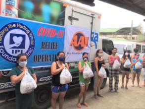 AAI volunteers with supply packages