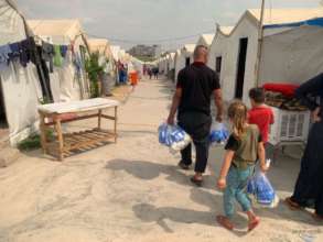 Camp residents bringing home the hygiene kits