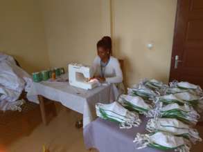 Nicoline producing reusble face masks in Buea