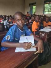Salma taking notes in the classroom