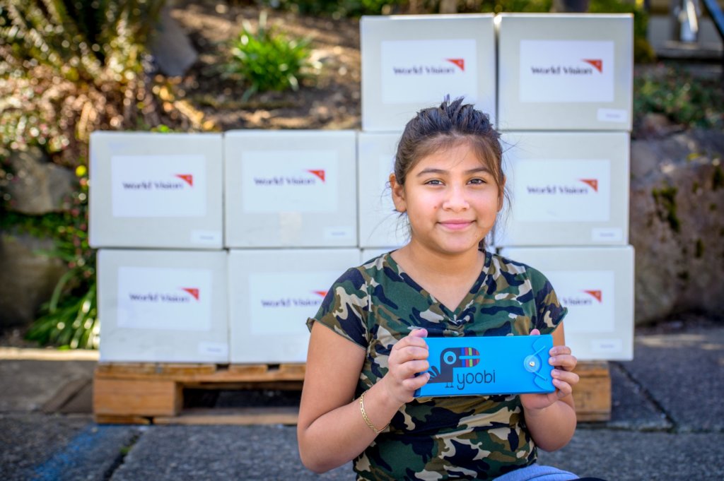 Receiving school supplies in her family's kit