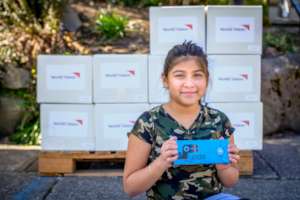 Receiving school supplies in her family's kit