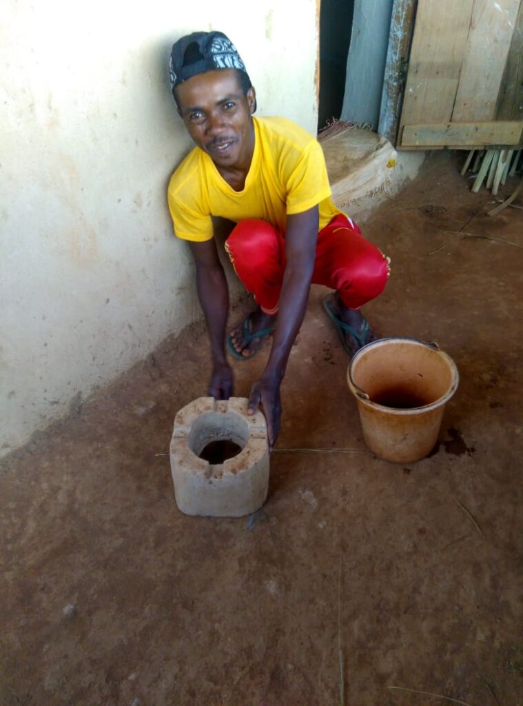 Jean-Liva with his cookstove model