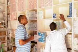 A pharmacist takes stock of available medicines