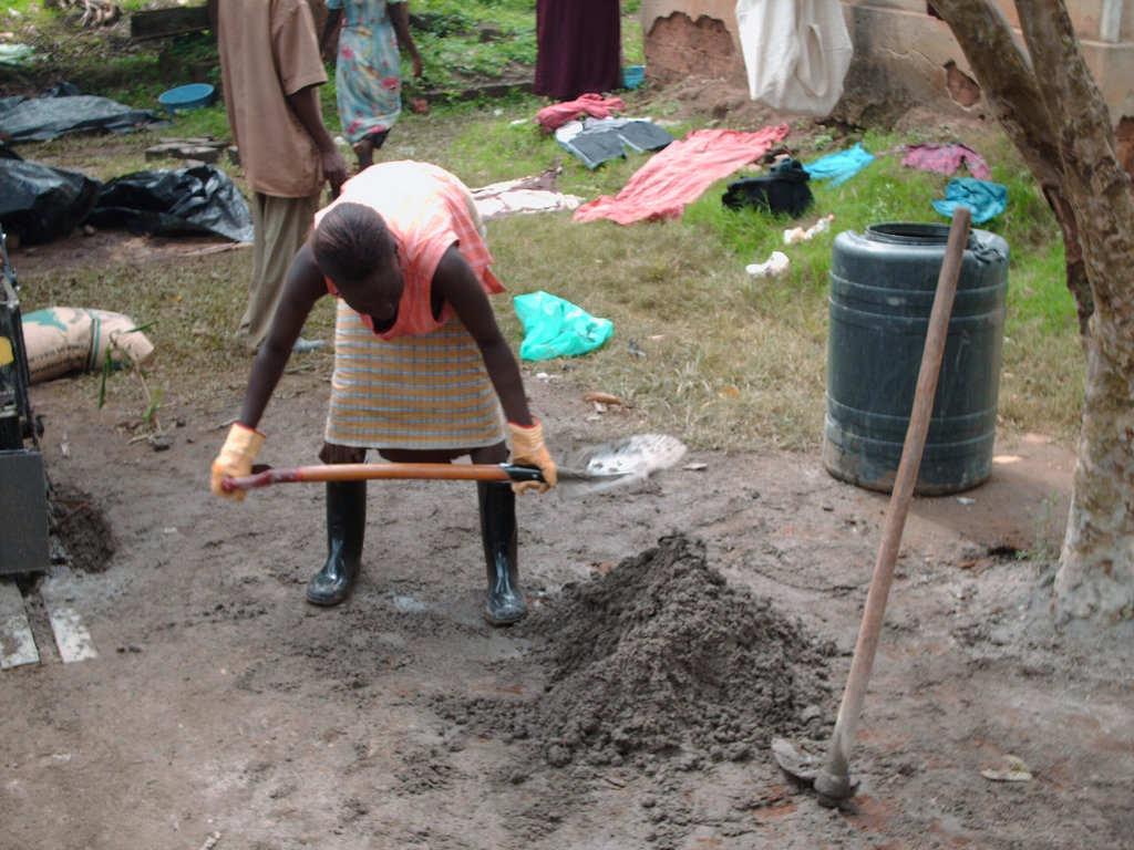 A woman making Red soil Block