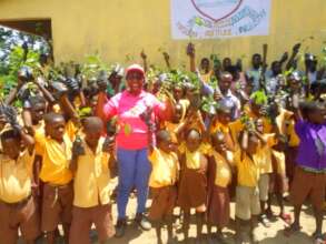 school children receive seedlings for planting