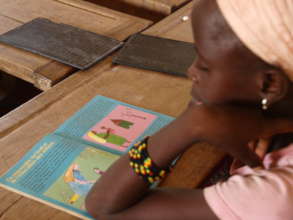 Girl reading values book in school