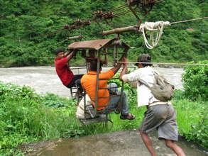 three men and cargo crossing the river