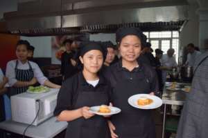 Female trainees completing their culinary cooking