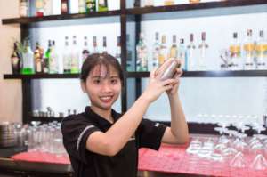 A KOTO trainee practices her cocktail making