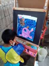 Student concentrating on his painting
