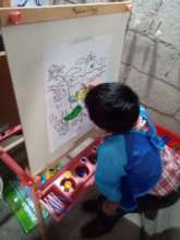 Student painting a turtle