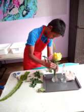 Male student doing a flower arrangement