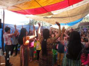 Volunteer teachers teaching students a new song