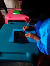 Student working on a rainbow scratch art project