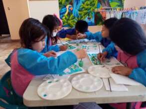 Students painting in the art area