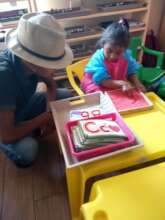 Instructor giving student lesson on letter writing