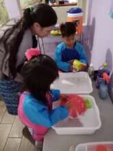 Students washing their dishes after snack