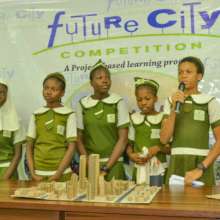 Girls displaying their  Smart city Model