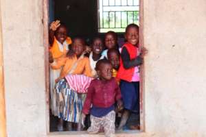 Children standing in the doorway of a classroom