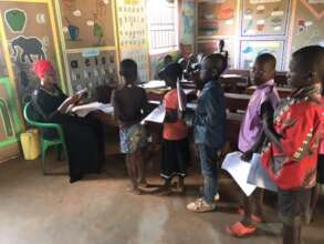 Children lined up to turn in their school work