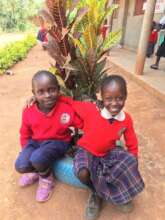 Two children smiling in their new uniforms