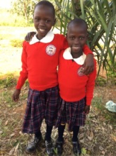 Sponsored sisters hugging