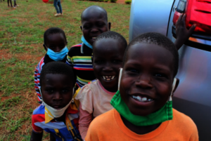 Children saying hello with masks on