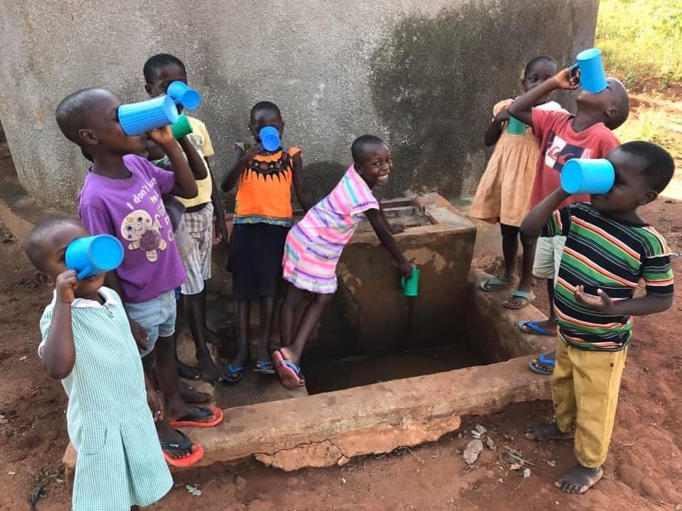 Children from Magooli Academy drinking clean water