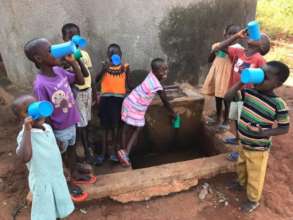 Children from Magooli Academy drinking clean water