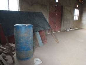 Blackboard and new school windows stored in church