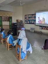 Primary school students watching a Tiflatoon story