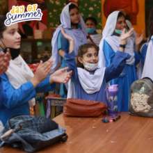 Students clap along to a musical performance