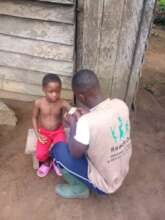 CHW assessing a boy for Malnutrition