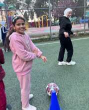 A girl and coach on the field in Madaba - Week 1!