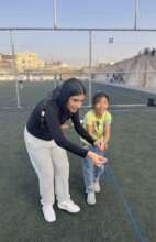 An older RC participant coaches a young girl