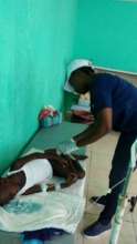 Treating a boy for cholera in Artibonite
