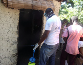 The team disinfecting a home to stop cholera