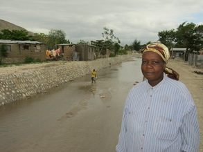 Camelita Cadet with the canal that saved her home