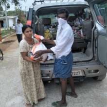 BASS staff distributing essential food kits