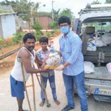 Project leader distributing relief to a family