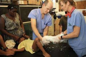 A clinical team sets the leg of a young patient