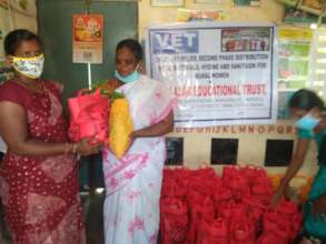 women receiving dry ration materials
