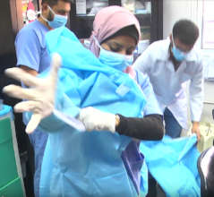Staff at Al Awda Hospital try on their new PPEs