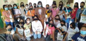 Girls in Cebu receiving 'Learn-at-Home Packs